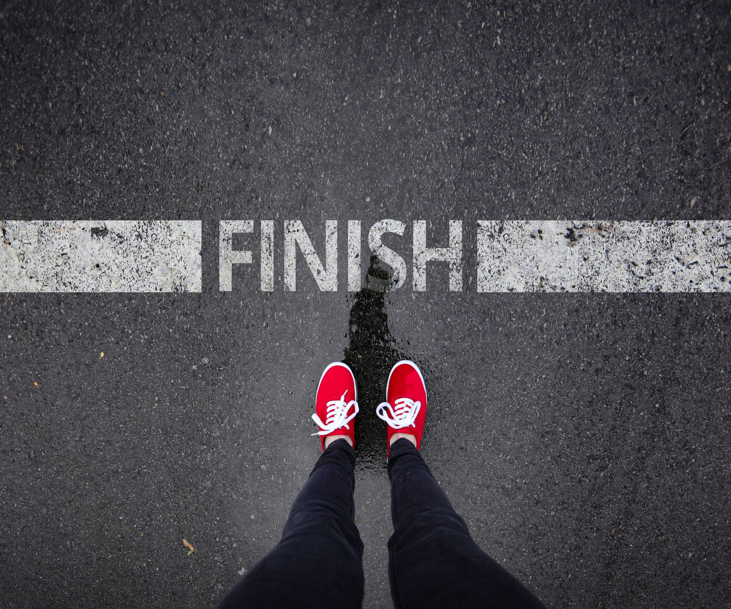 Red sneakers at painted finish line